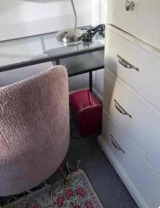 a desk with a chair next to a dresser at Upper single bedroom in Cardiff