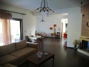 a living room with a couch and a table at DIAMOND Villa in Kimméria