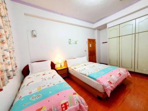 Posteľ alebo postele v izbe v ubytovaní Yilan Xiang Feng Homestay