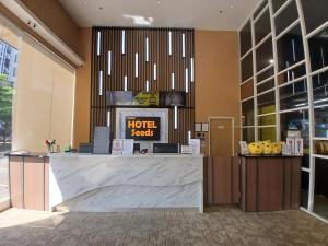 a hotel lobby with a hotel costs counter at Seeds Hotel Premier The Mines Seri Kembangan in Seri Kembangan