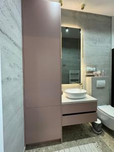 a bathroom with a sink and a mirror at Stari Toranj VI studio apartman in Vukovar
