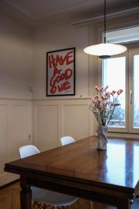 a dining room table with a vase of flowers on it at Boutique Apartment Lakeview Luzern 1 in Luzern