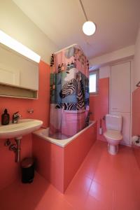 a bathroom with a zebra shower curtain and a sink at Boutique Apartment Lakeview Luzern 1 in Luzern +11 photos