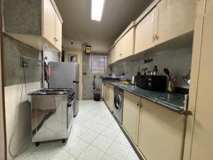 a kitchen with a refrigerator and a dishwasher at Sunset homes in Downtown Cairo in Cairo
