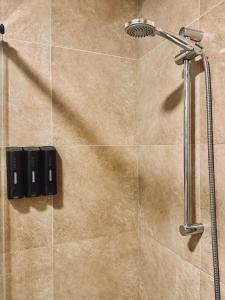 a shower with a shower head in a bathroom at Accommodation near the Cathedral LaCuevitadeLeo in Toledo +69 photos