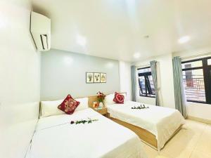 A bed or beds in a room at Luna House Hotel