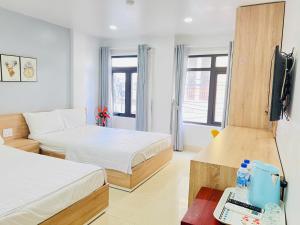 A bed or beds in a room at Luna House Hotel