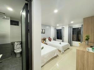 A bed or beds in a room at Luna House Hotel