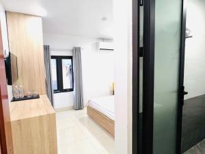 A bed or beds in a room at Luna House Hotel