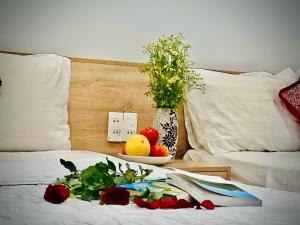 A bed or beds in a room at Luna House Hotel