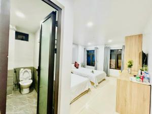 A bed or beds in a room at Luna House Hotel