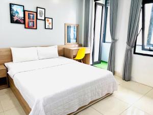 A bed or beds in a room at Luna House Hotel
