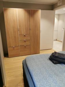 a bedroom with a bed and a wooden cabinet at Svolvær Apartment, Vestermyrveien 11 in Svolvær