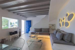 un soggiorno con un divano e un tavolo di Villa Iliana 1 & 2 w shared Pool, Ornos, Mykonos a Ornos