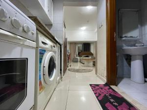 a washing machine in a bathroom with a sink at Reflections Ajman-Home Away Home-Best property for stay in Ajman 