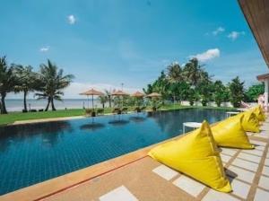a swimming pool with yellow umbrellas in a resort at Chan private in Cham Han