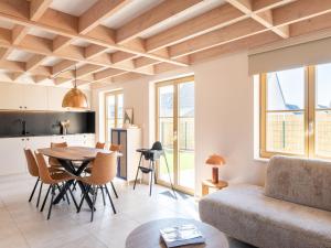 a living room with a table and a couch at Vakantiewoning Zilt Oostduinkerke in Koksijde
