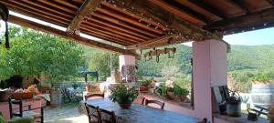 a patio with a table and a view of the mountains at Agriturismo Podere Tegline in Radda in Chianti +122 photos