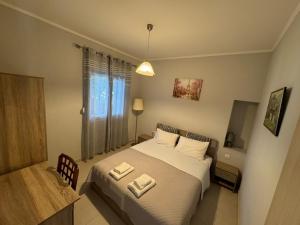 a bedroom with a bed with two towels on it at Suli Apartments in Limenas