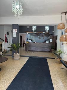 a lobby with potted plants in a building at Hotel Palace Piriápolis in Piriápolis +121 photos