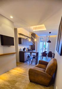 a living room with a couch and a kitchen at Case Vacanze 106 Maison De Charme in Giovinazzo