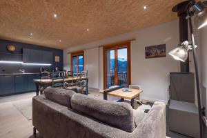 a living room with a couch and a table at La Forge de Diogne - luxury and cosy B&B Alpine lodge in Crans-Montana