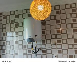 a light hanging from a wall in a kitchen at residence Eden Garden 1 in Abidjan +7 photos