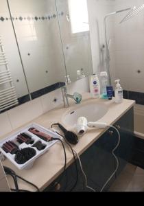 a bathroom counter with a sink and a mirror at Maison 10 pièces Spa jacuzzi Paris Airport CDG jardin arboré clos in Tremblay En France