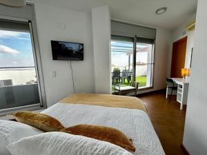 une chambre avec deux lits et une télévision au mur dans l'établissement Lo balconet del Delta. Àtic-dúplex vacacional., à Amposta