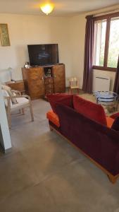 a living room with a couch and a television at La jolie Vue et La Maison de la Tour- Cordes-sur-Ciel in Les Cabannes +37 photos