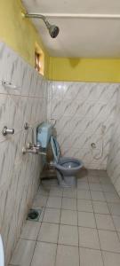 a bathroom with a blue toilet in a room at Laxmi in Arambol