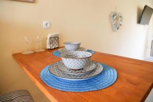 a table with three bowls on top of it at Joy's Houses in Marmari