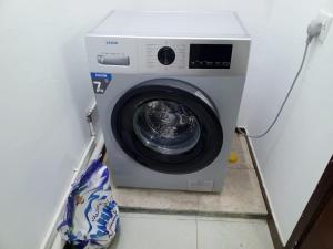 a washing machine is sitting in a room at 1 Separate Bedroom and Attached Bathroom in a shared apartment in Muscat