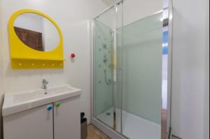 a bathroom with a shower and a sink and a mirror at La Maison Bleue, coeur de Barèges ski et randonnée in Barèges +18 photos