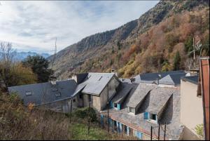 a group of buildings with mountains in the background at La Maison Bleue, coeur de Barèges ski et randonnée in Barèges