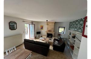 a living room with a couch and a table at La Maison du Foirail in Aurillac