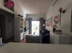 a living room with a couch and a table at lovely bungalow with parking in Playa del Ingles