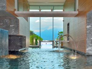 a swimming pool with a water slide in a building at Sibylle by Fewotessin in Locarno