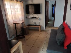 a living room with a couch and a table at casa Amarela in Tamoios