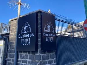 a sign for a business house on the side of a building at Business House in Naples
