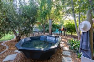a large tub in a yard with trees at Klein Nektar Wine & Olive Estate in Montagu