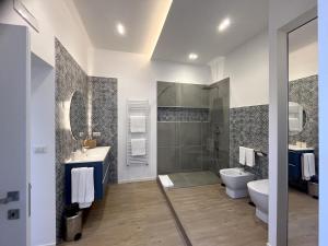 a bathroom with a toilet and a sink and a shower at Casa Vacanza 66 Cimarosa Suite in Aversa