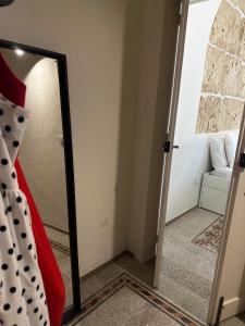a mirror in front of a room with a couch at F Home in Noto