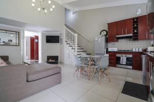 a kitchen and living room with a couch and a table at Waterfront - Lagoon Terrace Nr.17 in Knysna