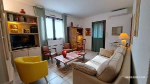 a living room with a couch and a table at T2 de 55m avec jardin et parking privatifs in Aix-les-Bains