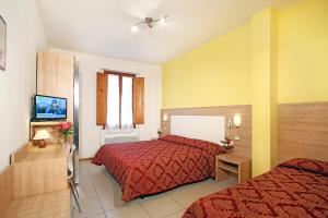 Ένα ή περισσότερα κρεβάτια σε δωμάτιο στο Hotel Marrani