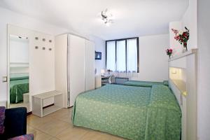 Ένα ή περισσότερα κρεβάτια σε δωμάτιο στο Hotel Marrani