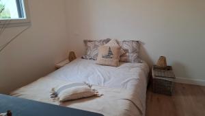 a small bedroom with a bed with pillows on it at Chambre d'hôtes Nova, petit déjeuner en supplément 5 euros par personne in Saint-Pair-sur-Mer +3 photos
