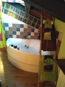 a bath tub in a room with a tiled wall at La Fuente in Umbrías