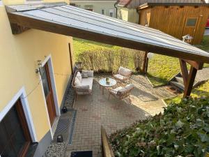 an outdoor patio with two chairs and a table at Ferienwohnung Michaela in Neualbenreuth +2 photos